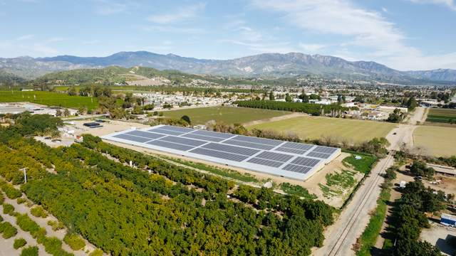 Covered reservoir beside the rail line, valley and mountains beyond