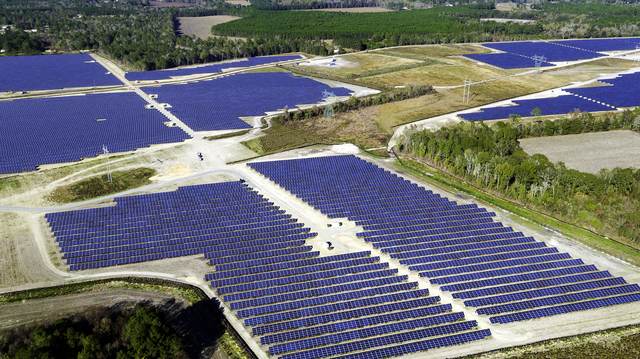 Aerial of solar rows crossing cleared farmland