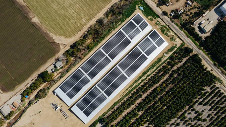 Overhead view of the two solar-covered reservoirs bordered by citrus orchard and open field